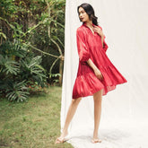 Flowy tiered mini dress in silk with gathered sleeves and soft V neckline